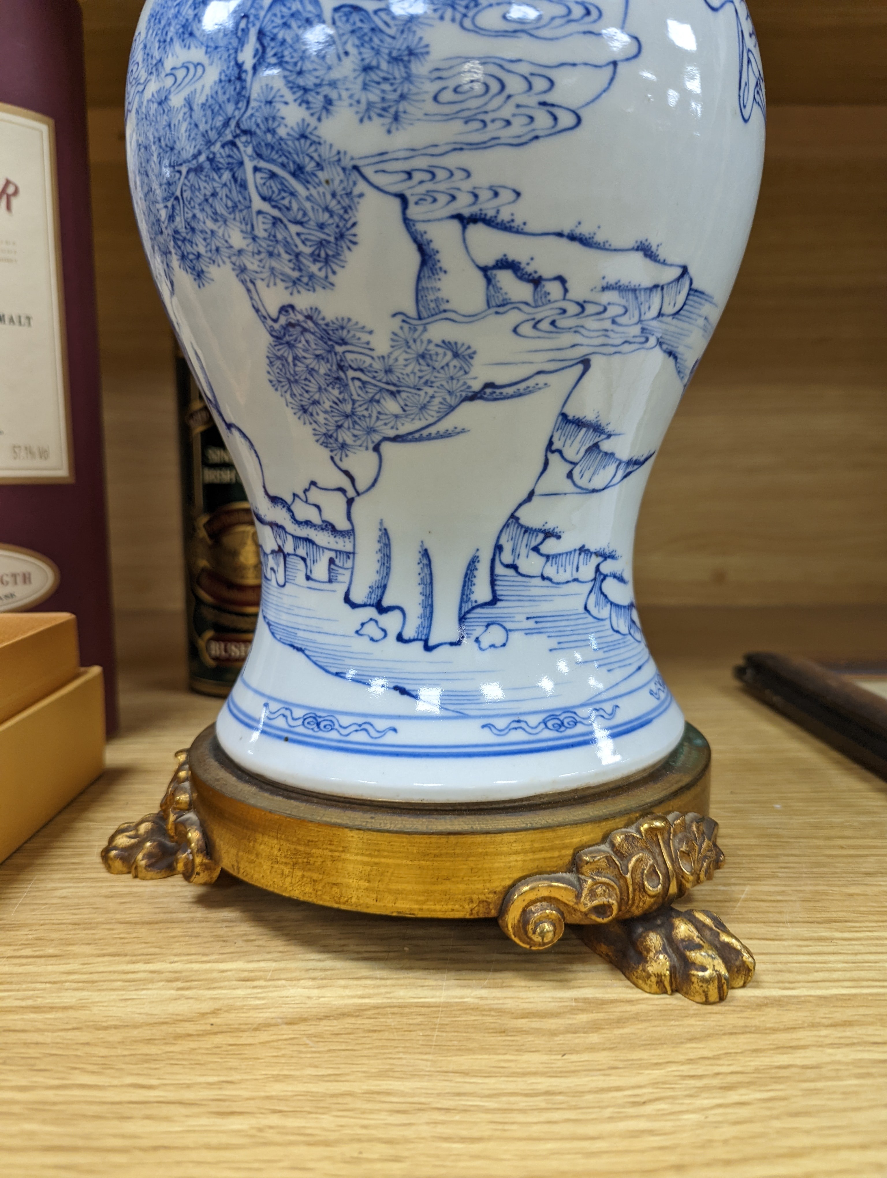 A Chinese blue and white baluster vase, brass mounted 29cm